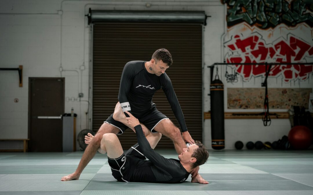 Two athletes grappling on the mat in a Brazilian jiu-jitsu match
