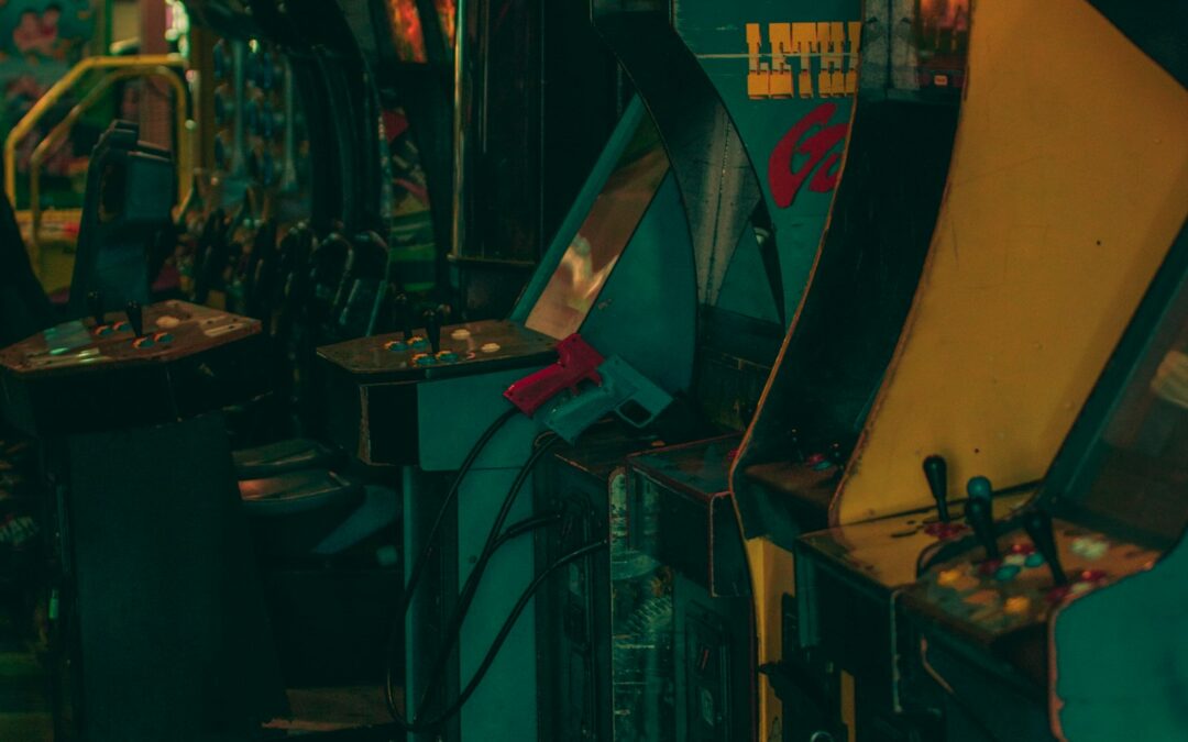 Row of arcade video game machines in a dark room