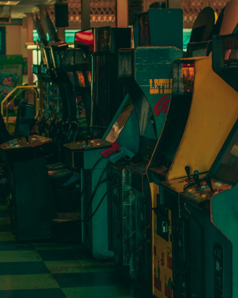 Row of arcade video game machines in a dark room