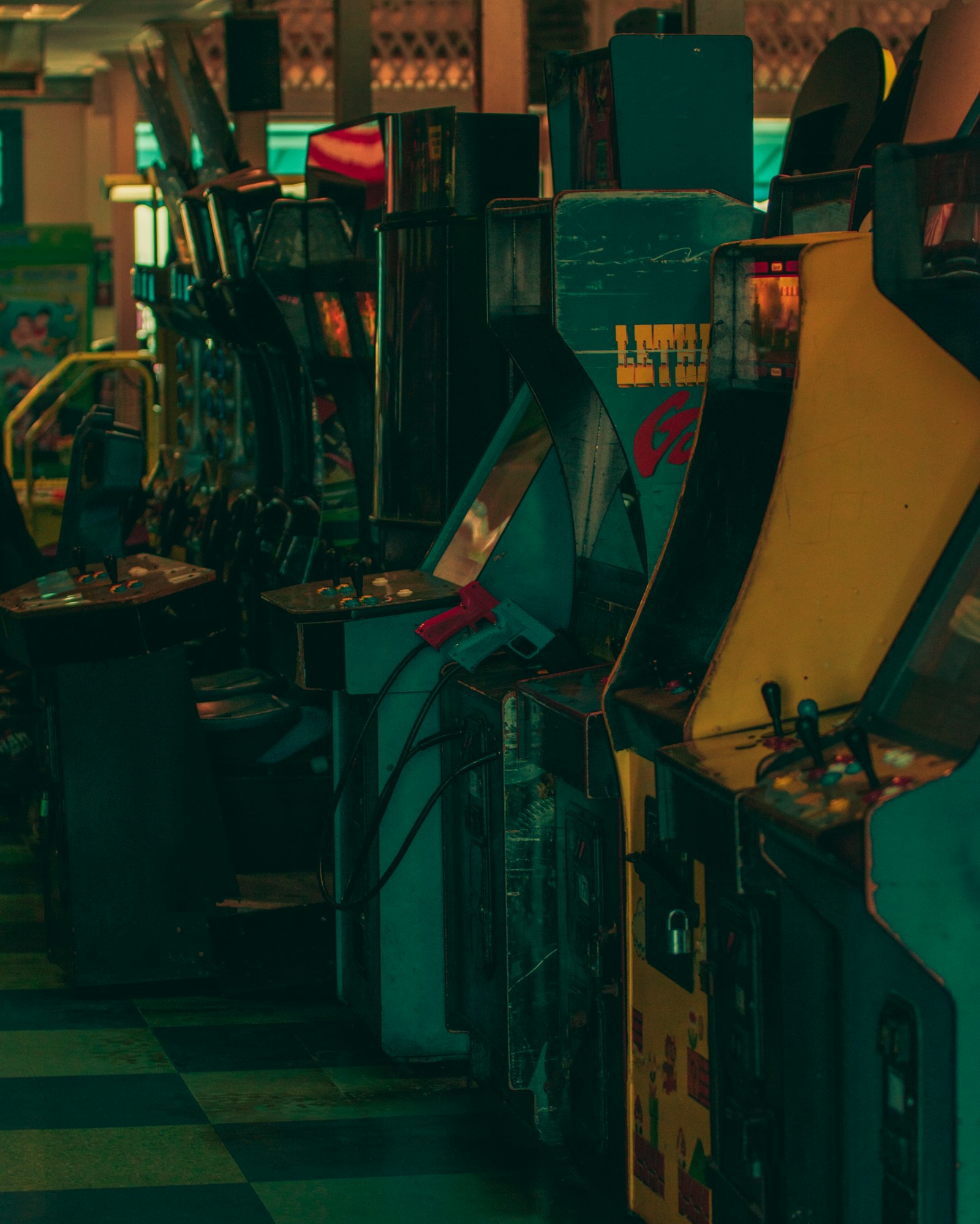 Row of arcade video game machines in a dark room